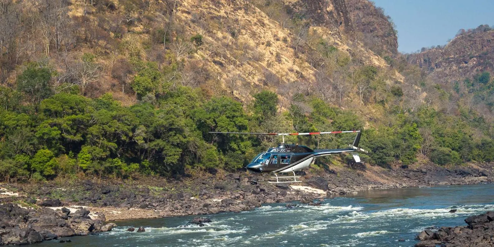 Victoria Falls from above — full width of the falls visible from the helicopter at cruising altitude
