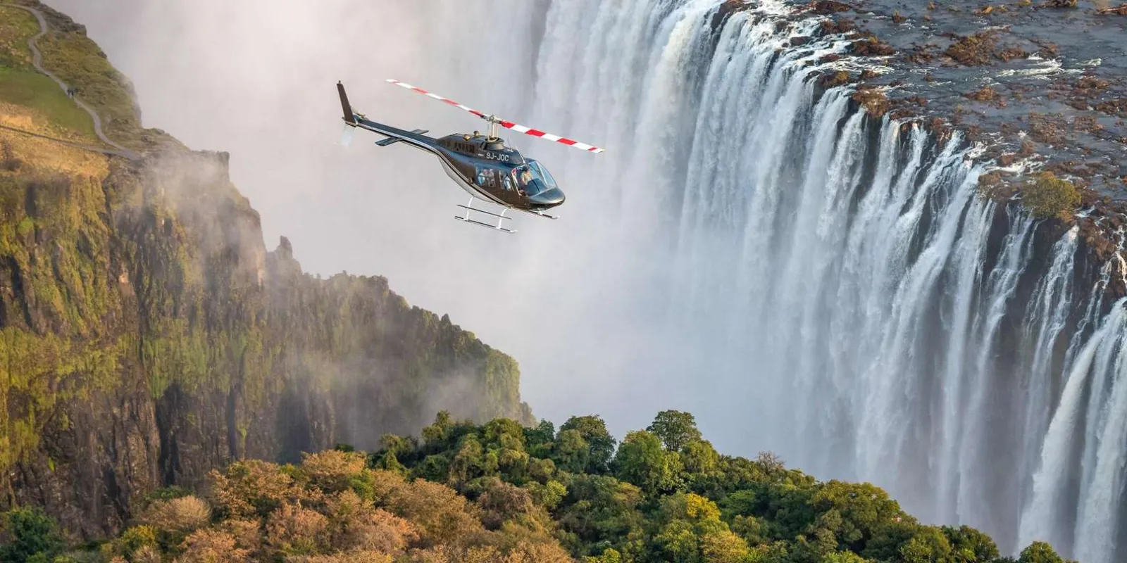 Helicopter tour departing Livingstone Airport — aerial view of the Zambian landscape and Victoria Falls area