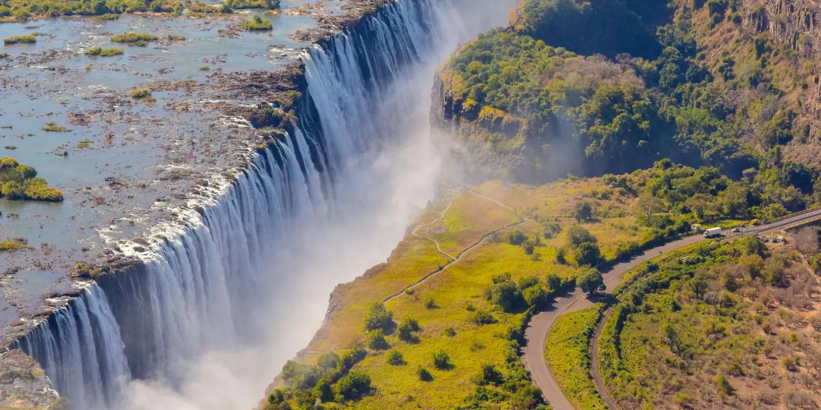 Victoria Falls curtain seen from helicopter altitude — full 1.7 km width visible